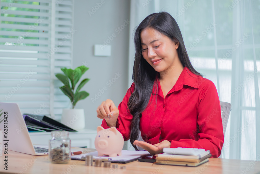 A middle-aged businesswoman sits indoors in the sunshine, smiling with satisfaction, thinking about finances, saving, investing and retirement planning for a successful future. A middle-aged businesswoman sits indoors in the sunshine, smiling with satisfaction, thinking about finances, saving, investing and retirement planning for a successful future.