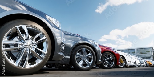 The sleek lineup of modern cars at a vibrant dealership under a sunny sky.