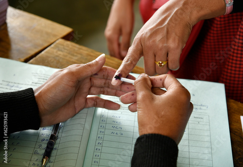 An Indian voter gets inked after casting her vote during the general elections, symbolizing democratic participation and civic duty in India.