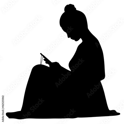 Silhouette of woman using phone, sitting down on floor. Silhouette features woman absorbed by device, illuminated by the screen's light. Captivating silhouette for tech-focused ad campaigns.