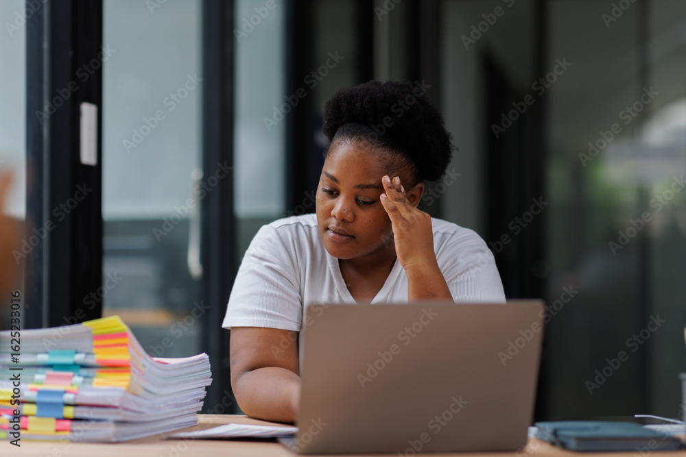 Fototapeta premium Migraine, business and black woman in office with laptop for editing report, burnout or project deadline. Fatigue, stress and female employee with eyes closed for headache, anxiety or overworked 