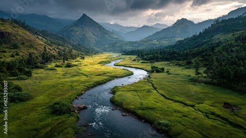 A serene river winds through a lush green valley scenic landscape with misty mountains in the distance golden sunrise