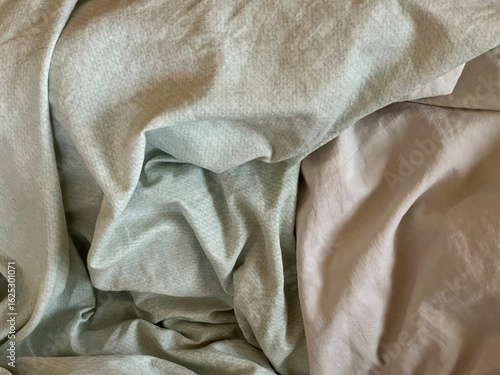 Close-up of light fabric bed texture – soft twisted bedding background