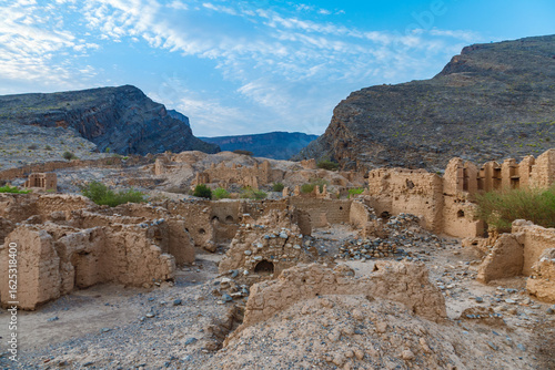 A view of the historic ruins of Old Tanuf village in Nizwa, Oman. The abandoned settlement is surrounded by mountains and built in traditional Omani architectural style, Sultanate of Oman . 