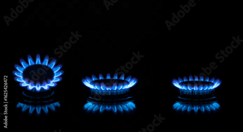 Captivating close-up of vibrant blue gas flames igniting on a sleek, modern stovetop against a dark, elegant background, showcasing culinary energy and warmth