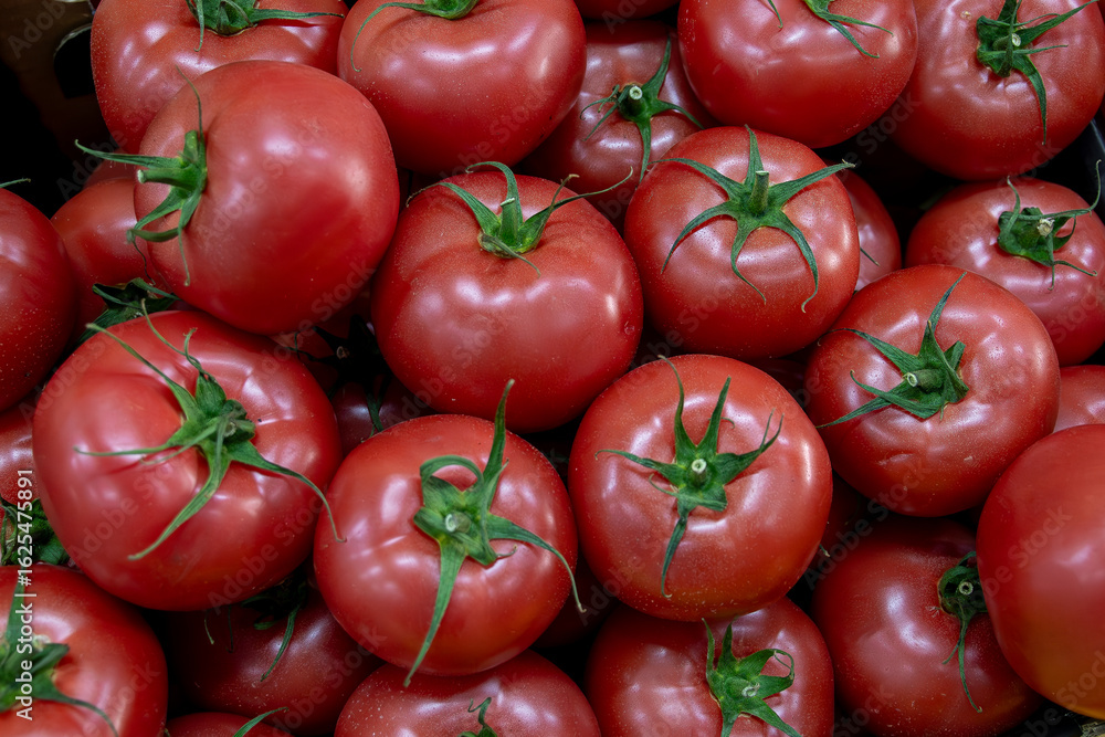 Many ripe red tomatoes. Cherry tomatoes. Pink tomatoes. Tomatoes in a box. Sale of tomatoes at the market and store. Background. Top view. Concentration sale at the market and store. Farm products. Many ripe red tomatoes. Cherry tomatoes. Pink tomatoes. Tomatoes in a box. Sale of tomatoes at the market and store. Background. Top view. Concentration sale at the market and store. Farm products.