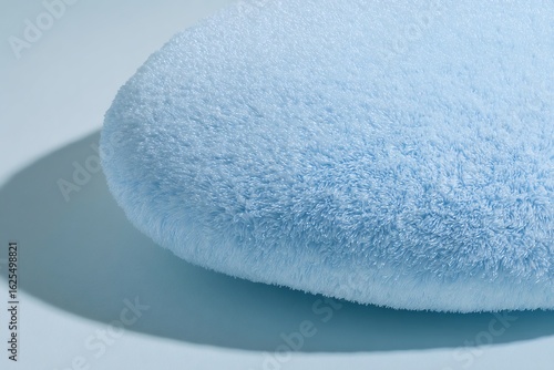 Plush drop shaped cushion pale blue tone macro detail minimalist product photography