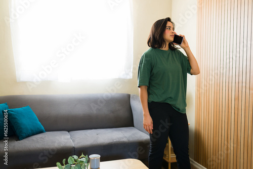 Cuadro en lienzo Hispanic freelancer working from home talking on phone