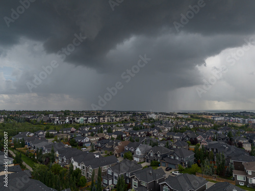 Thurnderstorm rolling over houses in Calgary, Alberta in summer.