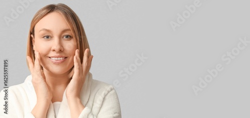 Woman massaging her face on...