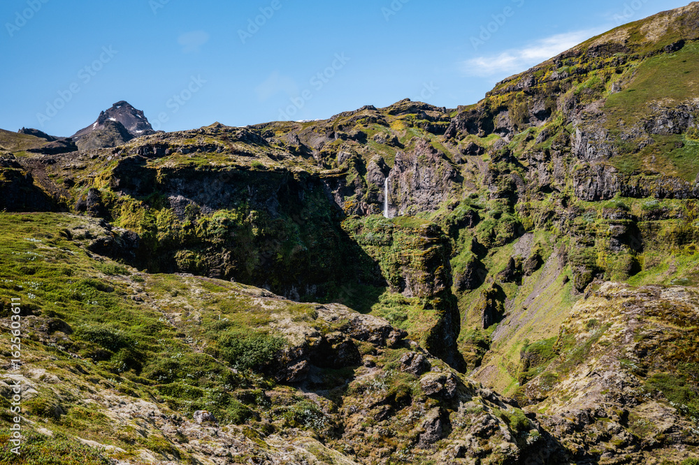 Fototapeta premium Mountain Landscape with Waterfall in Rugged Terrain