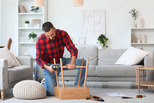 Young man with drill assemb...