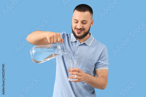 Young man pouring water int...