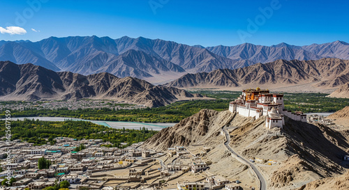 Majestic Thiksey Monastery perched on a hill, overlooking the Indus River and rugged mountains in the stunning landscape of Ladakh, India.