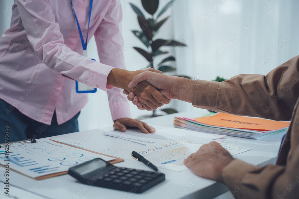 Naklejka premium Business handshake for teamwork of business merger and acquisition,successful negotiate,hand shake,two businessman shake hand with partner to celebration partnership and business deal concept See les