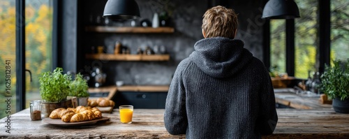 Wallpaper Mural Sluggish day for fatigue effect concept. A person enjoying a cozy breakfast in a modern kitchen setup. Torontodigital.ca