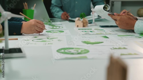 Wallpaper Mural A dynamic scene capturing business professionals engaged in analyzing green strategies using charts and graphs. The modern office setting highlights collaboration and innovation. SACTR Torontodigital.ca