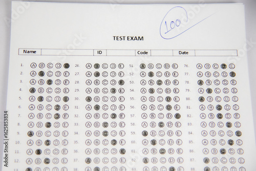 shows a hand holding a blue pen and writing the number 