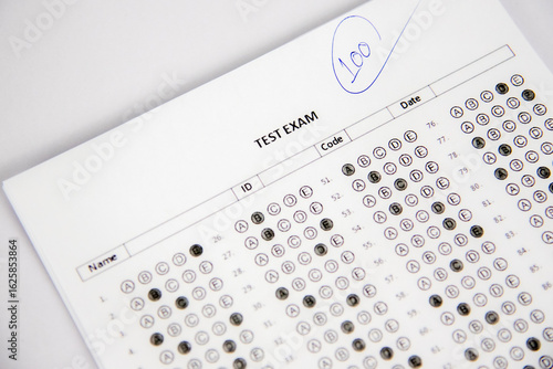 shows a hand holding a blue pen and writing the number 