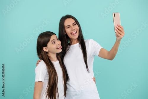 Selfie with mother and daughter. Capture the moment, cherish the memory. Portrait together with mother and daughter. Mother and daughter capturing selfie. Mother and daughter make selfie.