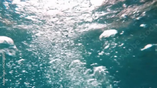 Wallpaper Mural Effervescent air bubbles blubbing and rising through deep blue water towards the sunlit surface. Torontodigital.ca