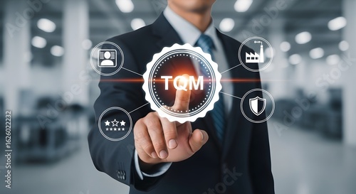 Professional touching TQM symbol with icons for quality, security, and industry standards, signifying total quality management strategy.