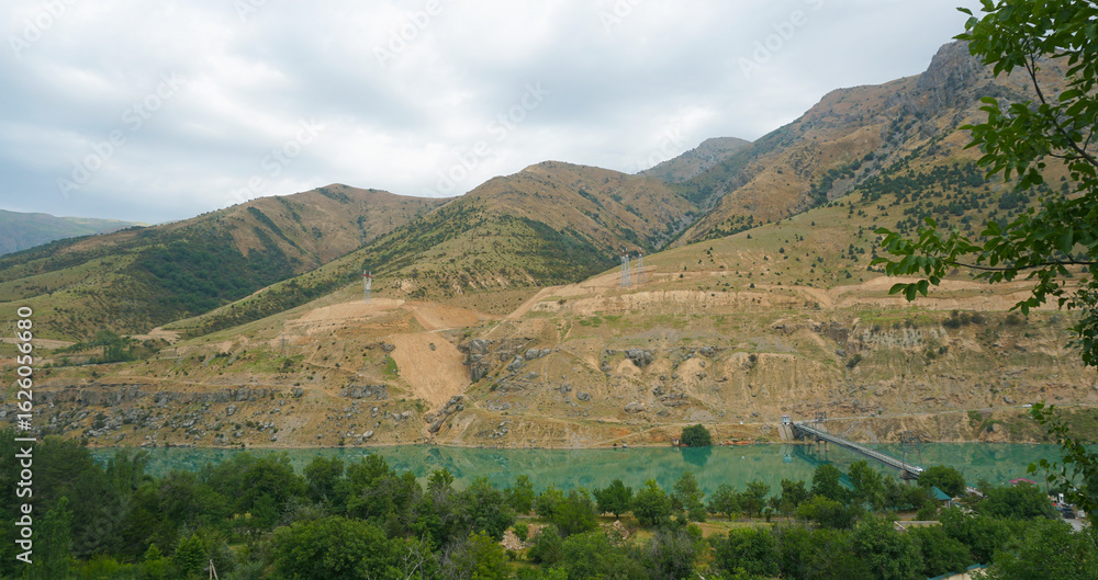 Naklejka premium Mountains are visible on the river bank.