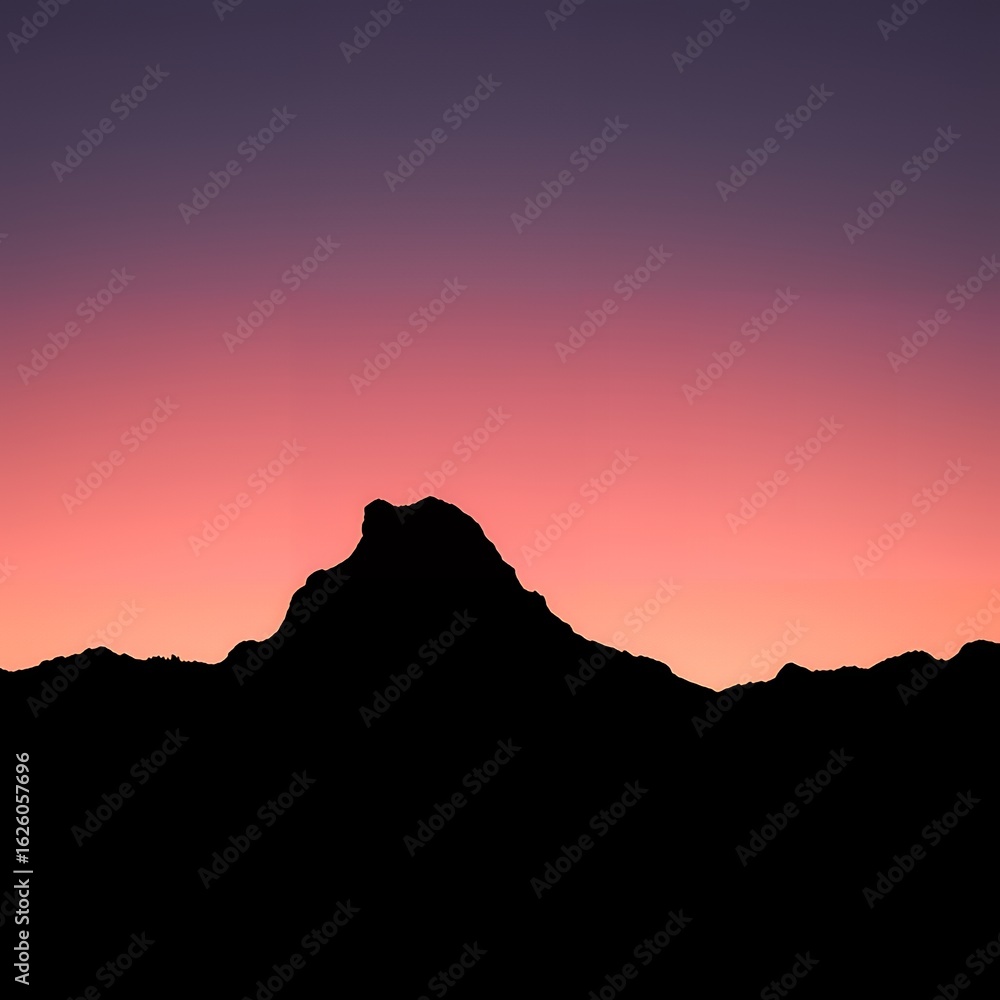 Fototapeta premium Dramatic mountain silhouette against a vibrant sunset sky