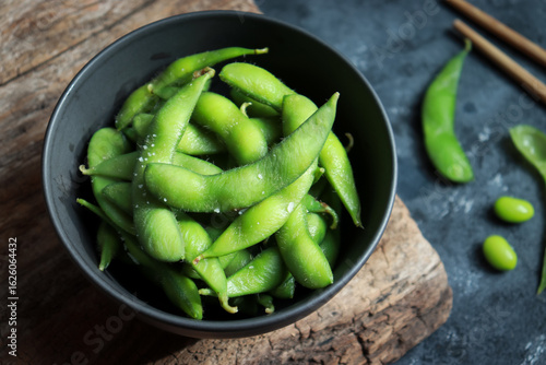 Green soybeans or Edamame in black bowl. Healthy snack and side dish in Asian food