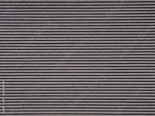 Sleek gray veneer surface with fine, uniform dark striations