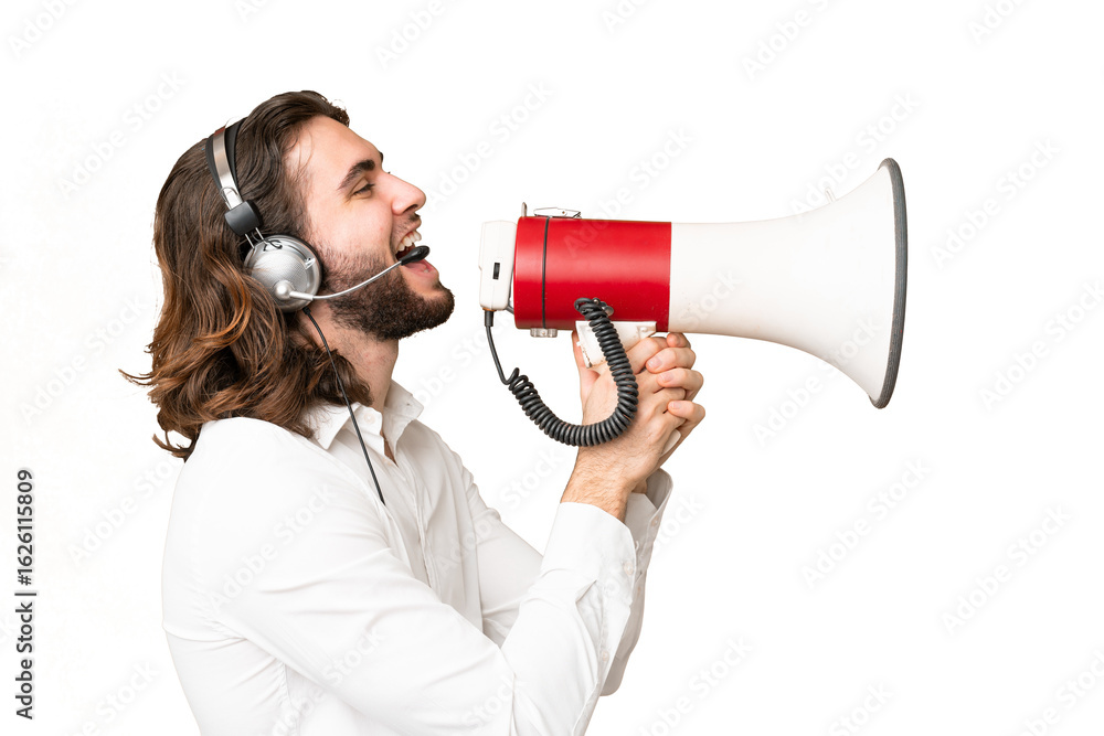 Naklejka premium Telemarketer man working with a headset over isolated chroma key background shouting through a megaphone