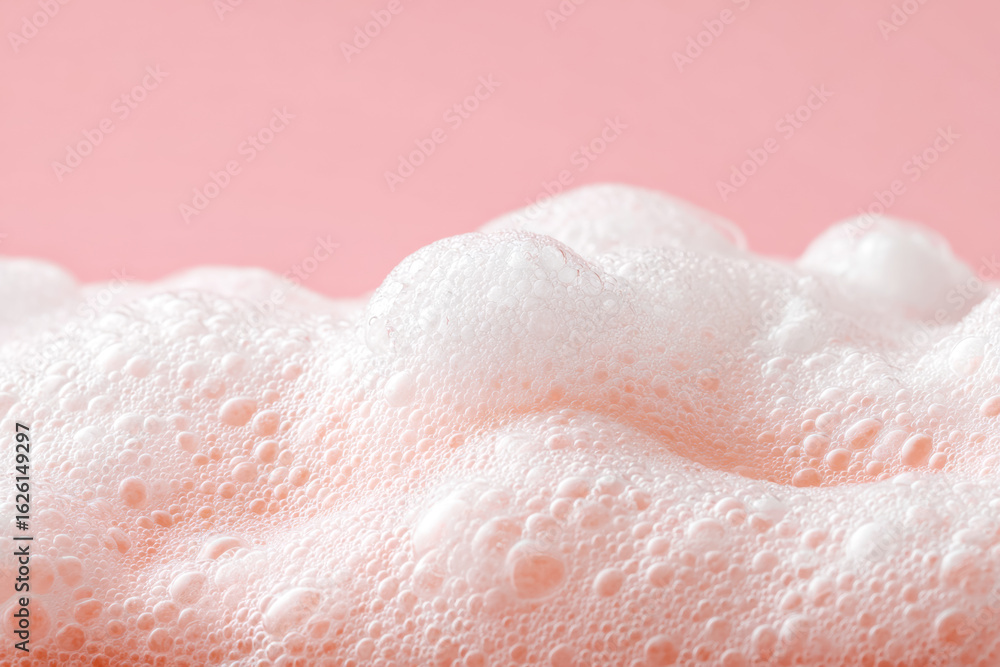 Fototapeta premium Close-up of pink bubbly foam on a pastel background