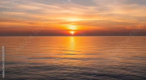 Magnificent sunrise over the serene ocean  casting a golden glow on the water