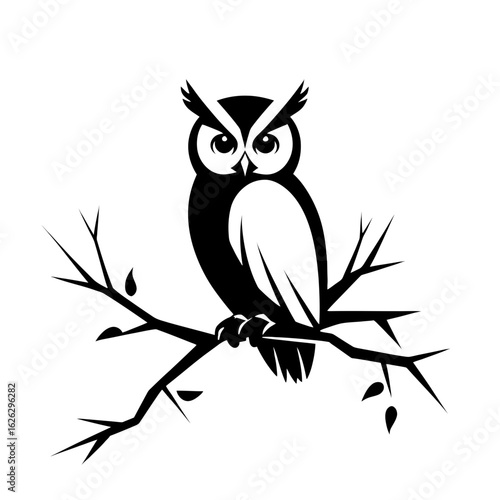 Black owl perched on a branch, nocturnal bird with a watchful gaze
