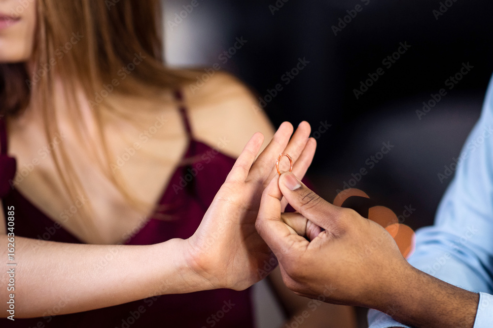 Fototapeta premium Woman rejecting marriage proposal from black boyfriend, refusing to take ring, saying no with open palm gesture. Young multiracial couple having relationship problems, cropped image, closeup