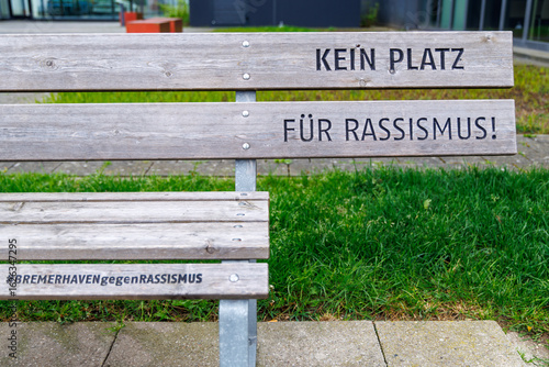 park bench with one seat missing (translation: no place for racism; #city of Bremerhaven against racism)