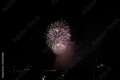 A photo of a fireworks is lit up the night sky