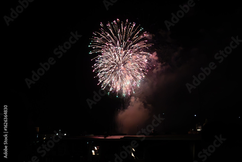 A photo of a fireworks is lit up the night sky
