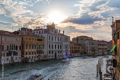 A photo of a canal with boats and buildings on it