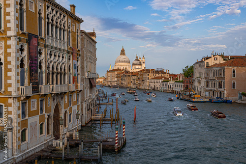 A photo of a view of a canal with boats and buildings