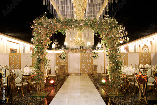 Elegant Wedding Entrance Arch Decorated with Flowers and Lights