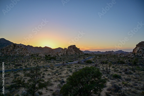 Close-up view of textured boulders and desert landscape at dusk in Joshua Tree.
