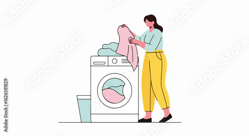 Young woman doing laundry at home. Person carefully folds clean clothes near washing machine. Domestic activity in modern apartment.