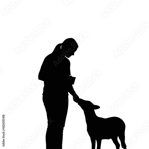 Silhouette of woman feeding small dog. Person giving food to pet animal. Happy pet owner feeding her small dog.