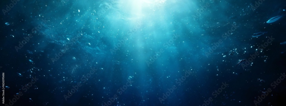 Obraz premium Abstract Underwater Scene with Glowing Light and Sparkling Particles in Shades of Blue