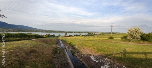 Wallpaper Mural Tranquil rural landscape with stream and Markazi Lake near Mátra mountains, Hungary Torontodigital.ca