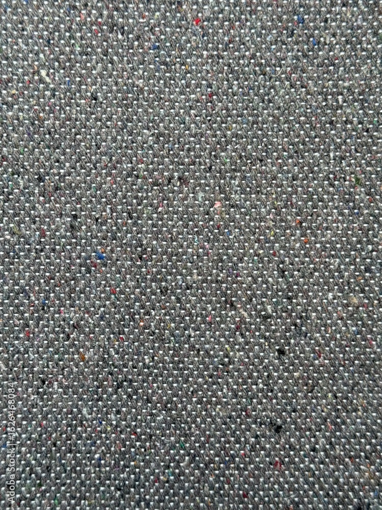 Fototapeta premium Vertical close-up of dark grey fabric texture background. Rich texture, tight weave gray material. Natural fibers detailed backdrop perfect for t-shirt designs, apparel, and textile projects