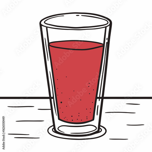 Glass of red tomato juice on wooden table  