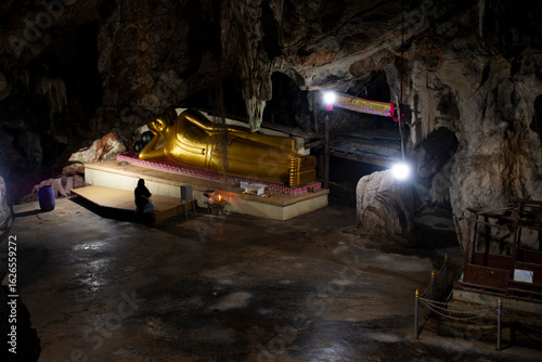 Bild auf Leinwand Ancient buddha reclining statue in antique cave for thai people travelers travel