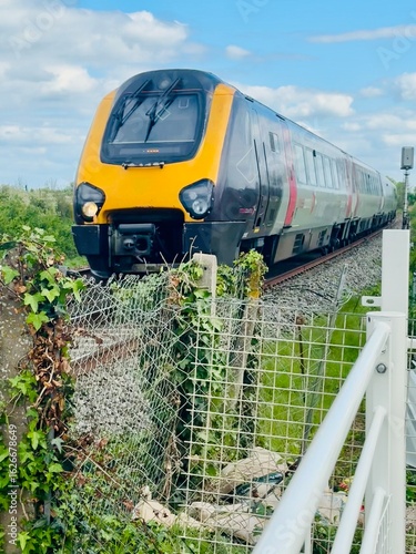 Modern Passenger Train Traveling Through Countryside